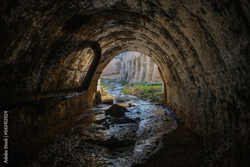 Exit from vaulted sewer tunnel. Underground river, view from inside of sewer tunnel