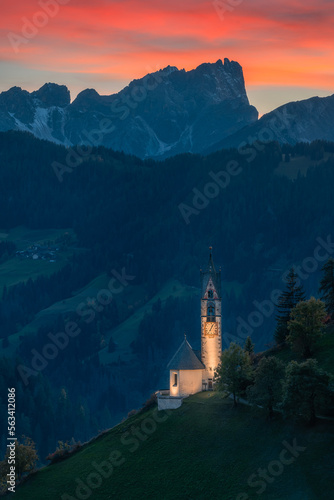 Small church in the mountain at sunset and night, Chiesa di Santa Barbara in Dolomite Alps, Italy