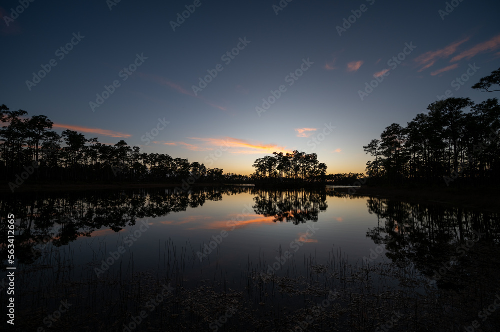 Obraz premium Sunset cloudscape over and reflected in water at Long Pine Key in Everglades National Park, Florida.