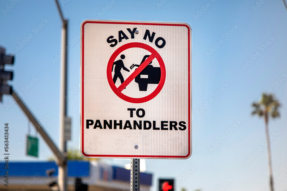 A sign with a pictograph discouraging panhandling A sign with a pictograph discouraging panhandling