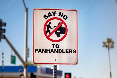 A sign with a pictograph discouraging panhandling photo