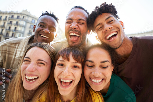 Close up of Five cheerful faces of young friends taking selfie portrait. Happy multicultural people looking at the camera smiling fooling around. Concept of community, youth lifestyle and friendship.