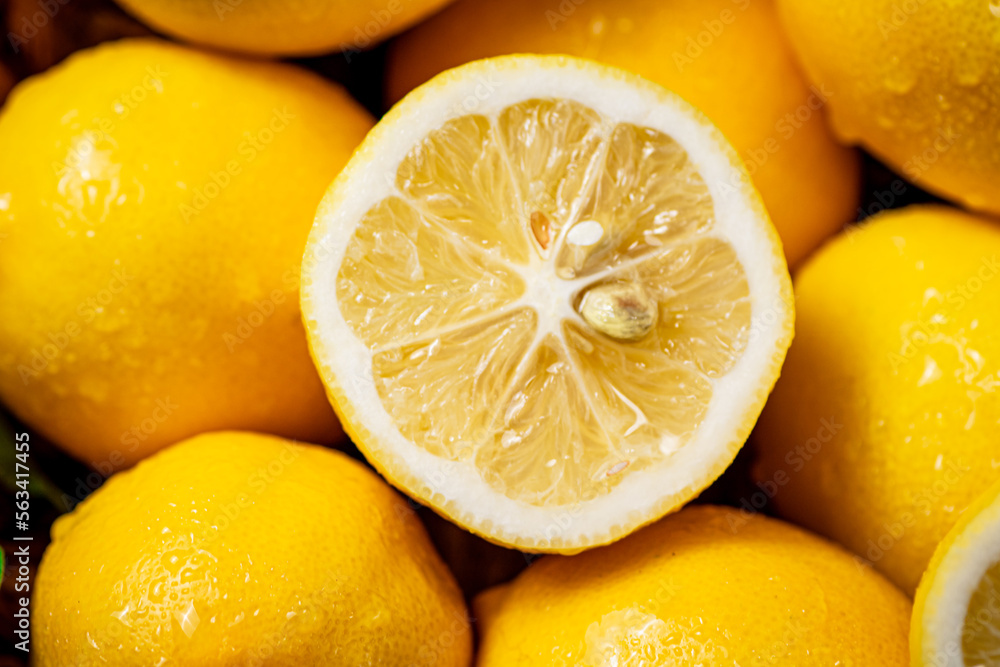 Halves and whole fresh lemons. Macro background. Halves and whole fresh lemons. Macro background.
