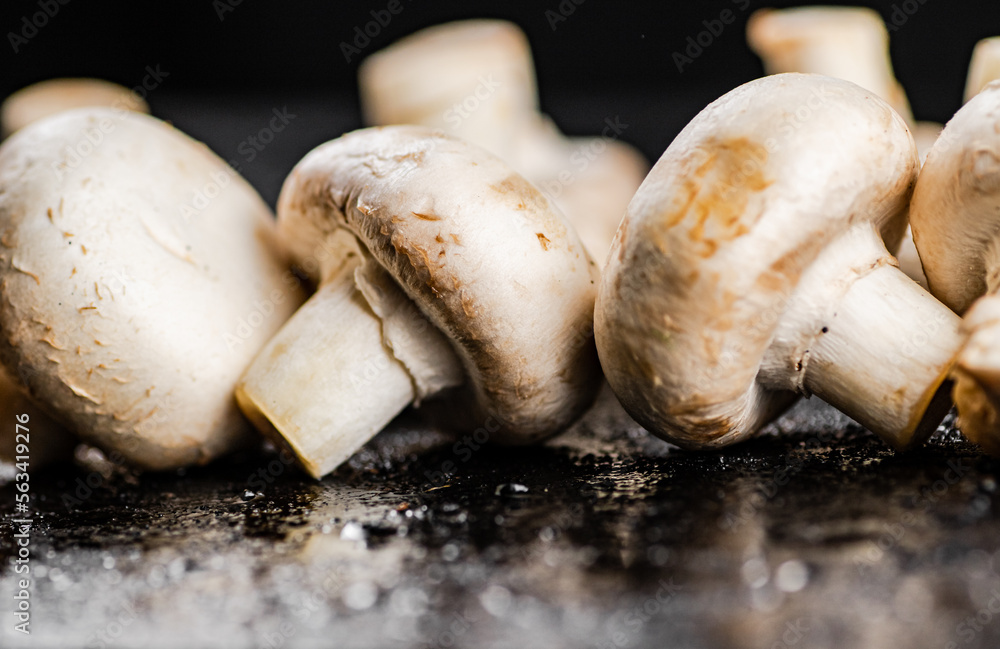 Fresh mushrooms champignons on the table. Fresh mushrooms champignons on the table.