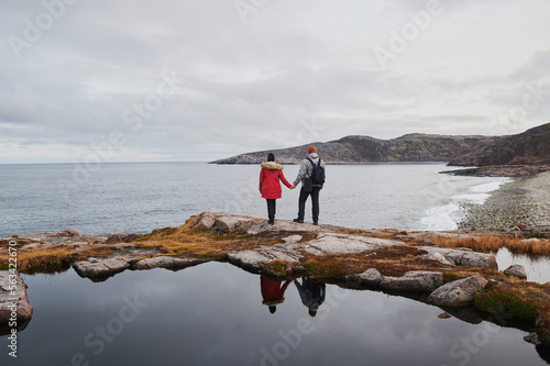 Senior couple standing overlooking an ice-covered. photo