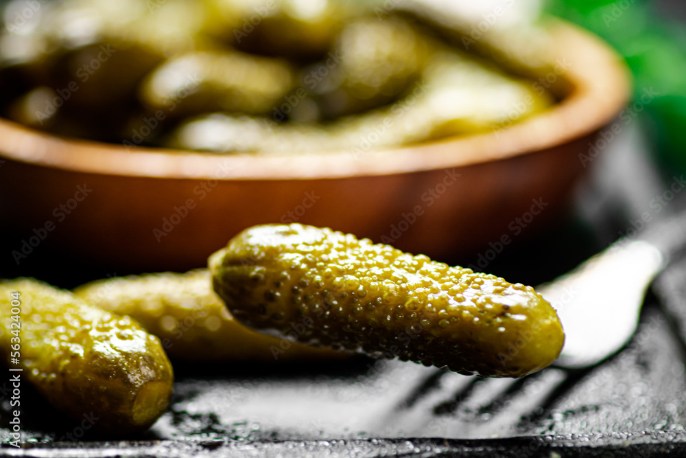 Wooden plate with pickles. On a black background. Wooden plate with pickles. On a black background.