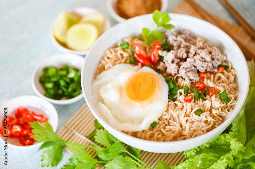 noodles bowl with boiled egg minced pork vegetable spring onion lemon lime lettuce celery and chili on table food , instant noodles cooking tasty eating with bowl - noodle soup noodles bowl with boiled egg minced pork vegetable spring onion lemon lime lettuce celery and chili on table food , instant noodles cooking tasty eating with bowl - noodle soup
