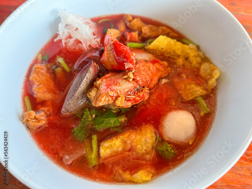 Food Thai style noodle with assorted tofu and fish ball in red soup - Asian food style pink seafood flat noodles on soup bowl