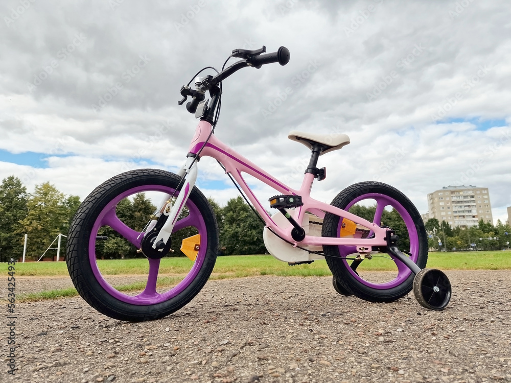 Girls bicycle outside during summer Girls bicycle outside during summer