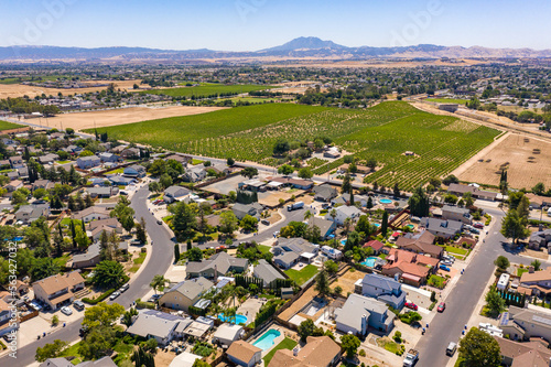 Drone photos over a community in Northern California. With houses, trees and a blue sky