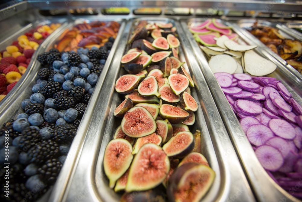 Fototapeta premium Close-up of White Sierra Figs with Fruits and Vegetables at a Salad Bar