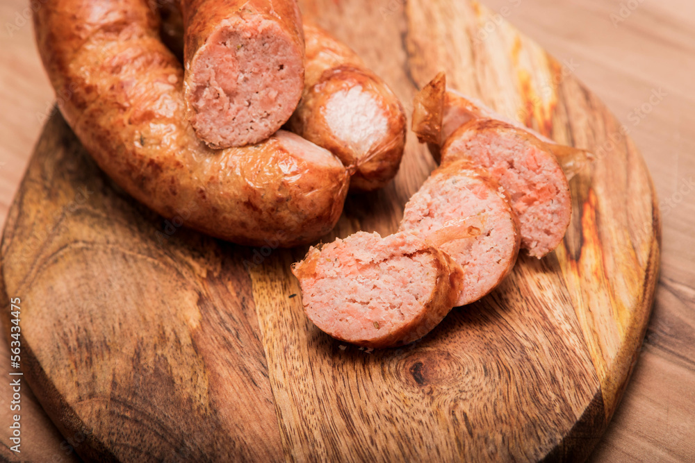 salmon sausage, On a wooden textured background wooden cutting Board with on which salmon sausage grilled. Top view macro. salmon sausage, On a wooden textured background wooden cutting Board with on which salmon sausage grilled. Top view macro.