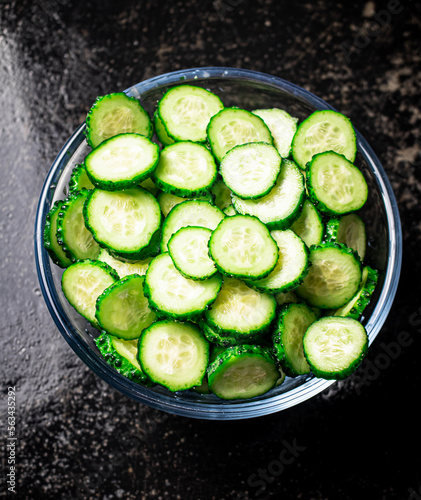 Full glass bowl of chopped fresh cucumbers. 