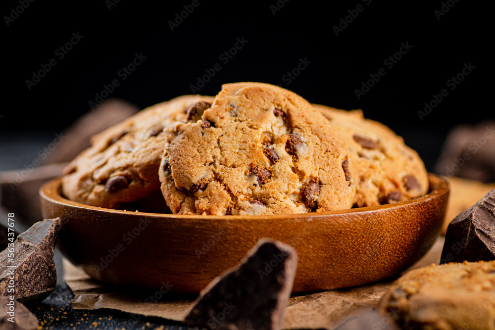 Fototapeta premium Delicious cookies with pieces of milk chocolate on a plate.