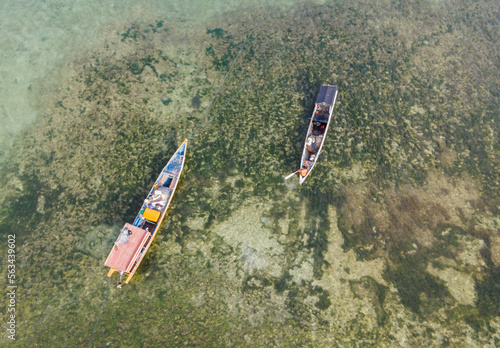 Aerial view of traditional boats at Kelapa Lima Beach, a tropical beach and coastline located in Kupang, East Nusa Tenggara, Indonesia. A Popular tourist destination.  photo