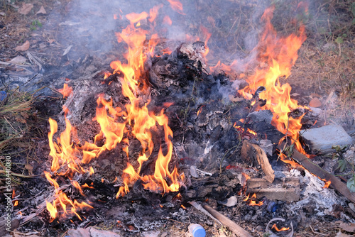 burning trash pile of flames.