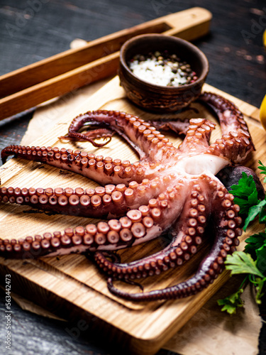 Octopus on a wooden cutting board. 