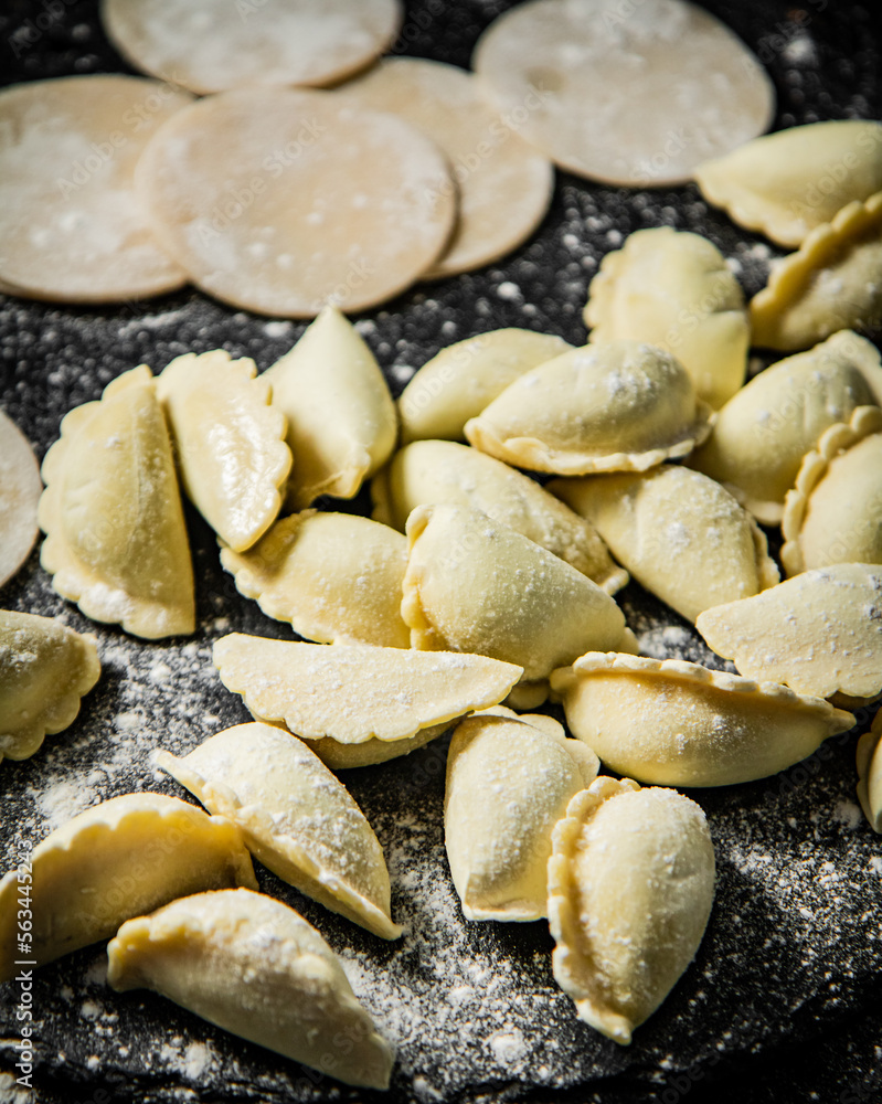 Making homemade potato dumplings. On a black background.