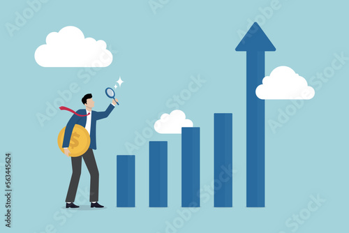 Financial market, investment earning or money management analysis, economic growth, stock exchange market report concept, businessman investor holding money coin analyze financial graph and chart.