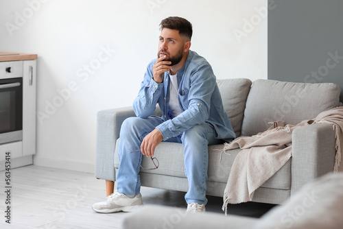 Stressed young man sitting ...