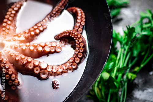 Octopus is boiled in a pot of water. 