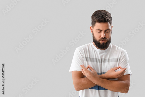 Handsome young man meditati...