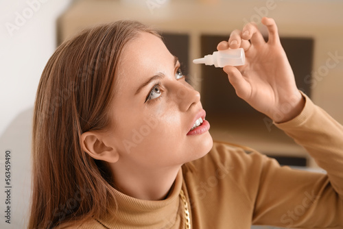 Slika na platnu Young woman using eye drops at home, closeup