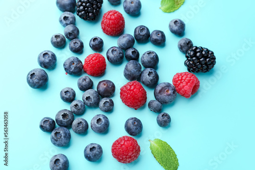 Different fresh ripe berries on color background  closeup