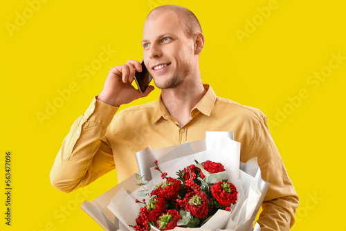 Young man with bouquet of f...