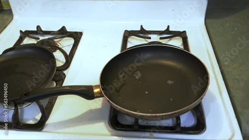 Frying pan on gas  stove sizzling   photo