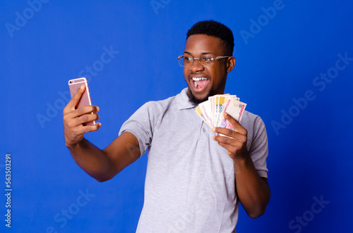 Cuadro en lienzo Young handsome African man on glasses taking selfie with his mobile phone and ho