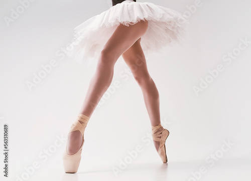 photo of a ballerina's legs in pointes showing a pa during a performance photo