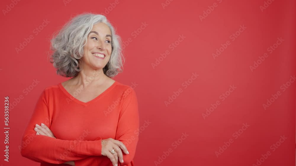 Smiley mature woman pointing to the side Smiley mature woman pointing to the side