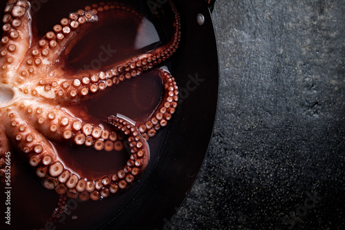 Octopus is boiled in a pot of water. 