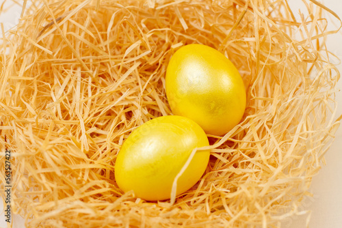 Easter flat lay of golden Eggs in yellow backset photo