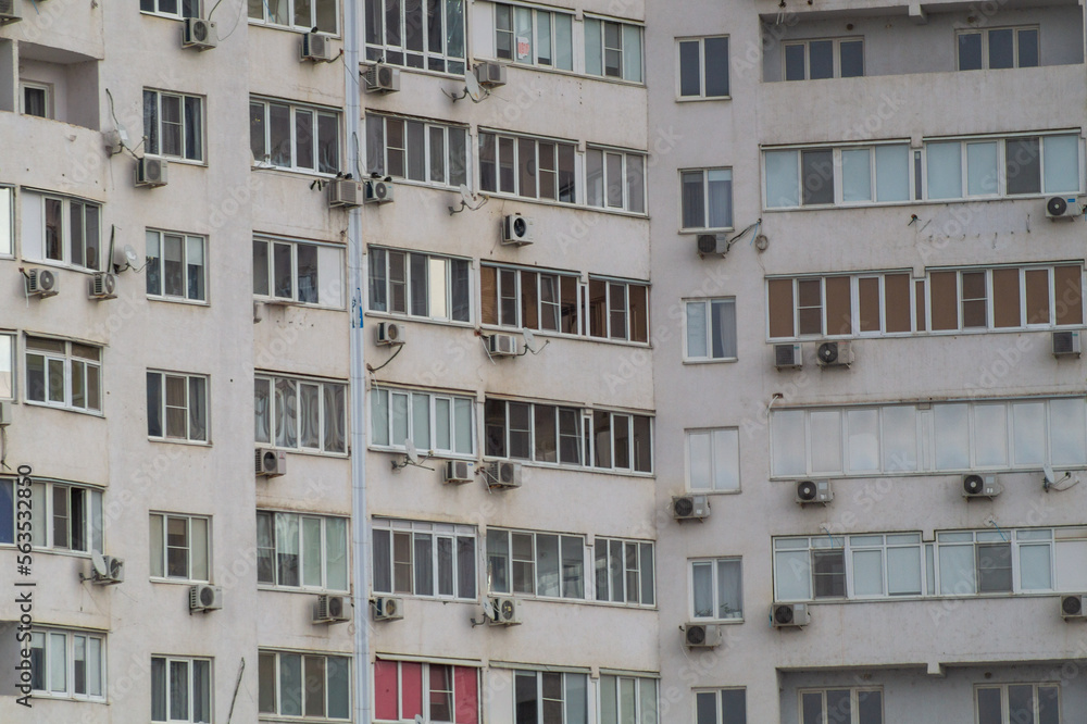 Close-up windows of a multi-storey residential building. Modern residential real estate in the city