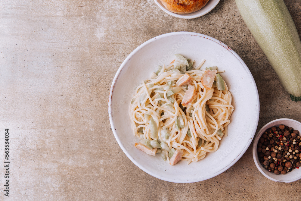 Pasta with zucchini. Homemade spaghetti with vegetables and sausage in a creamy sauce. Italian cuisine. Pasta with zucchini. Homemade spaghetti with vegetables and sausage in a creamy sauce. Italian cuisine.
