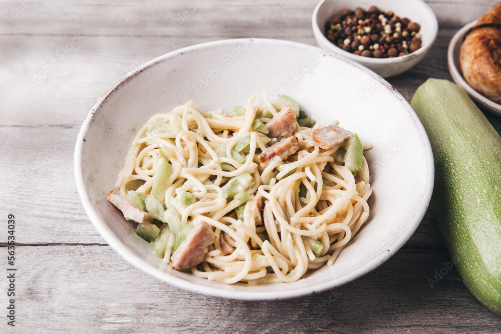 Pasta with zucchini. Homemade spaghetti with vegetables and sausage in a creamy sauce. Italian cuisine. Pasta with zucchini. Homemade spaghetti with vegetables and sausage in a creamy sauce. Italian cuisine.
