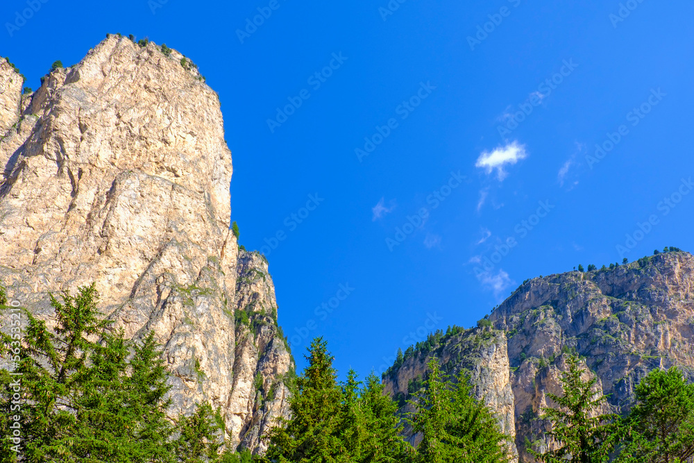 Mountain peaks and mountain walls against a blue clear sky