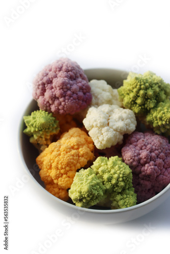 Various sort of cauliflower in a bowl on white background. Purple, yellow, white and green color cabbages and  green Romanesco or Roman cabbage