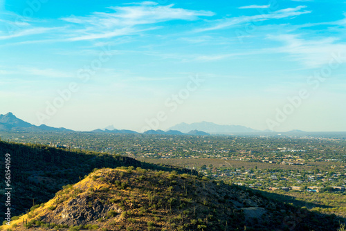 Hillside mounds in the moutains of Tuscon Arizona in late afternoon with suburban and urban neighborhoods photo