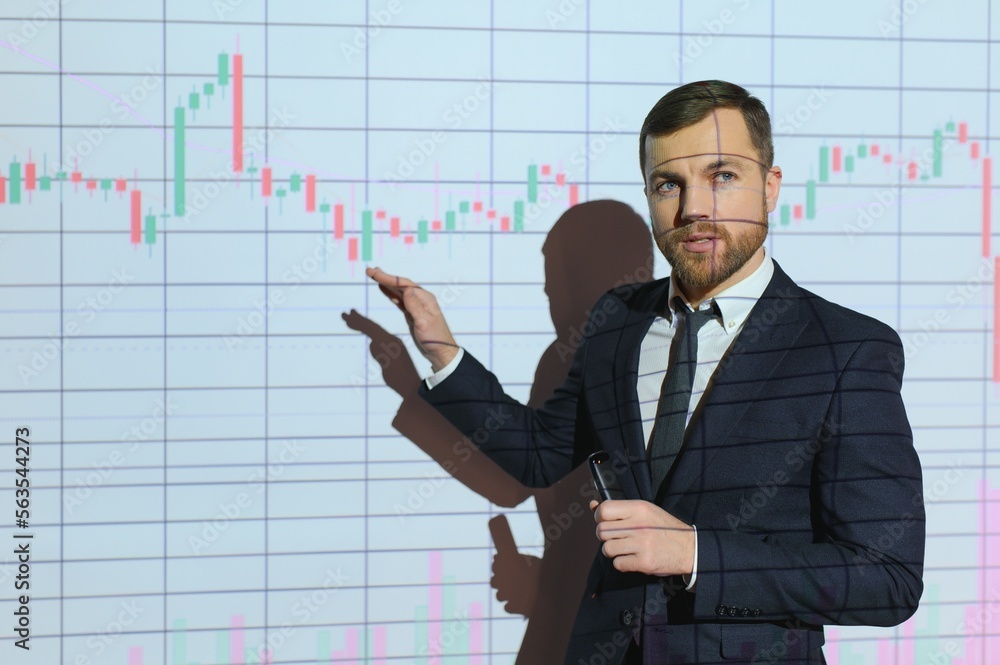 Man is standing near projector and showing graphs and business graphs. Man is standing near projector and showing graphs and business graphs.