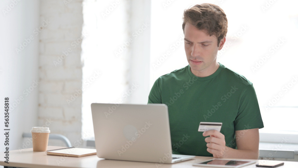 Happy Young Man Shopping Online on Laptop Happy Young Man Shopping Online on Laptop