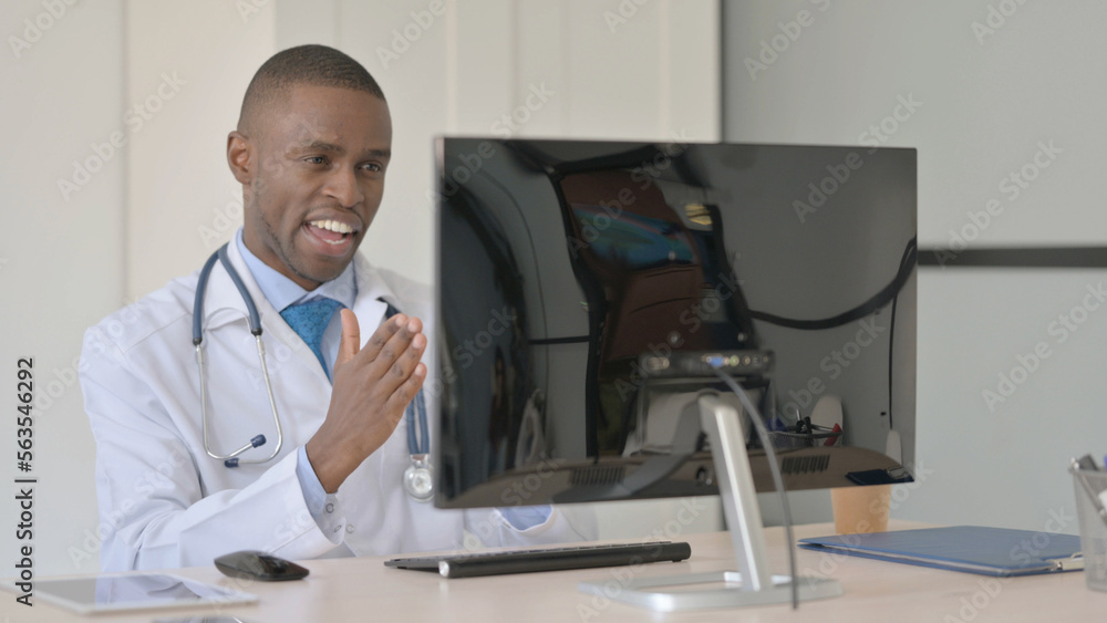 African Doctor Talking on Video Call on Laptop in Clinic African Doctor Talking on Video Call on Laptop in Clinic