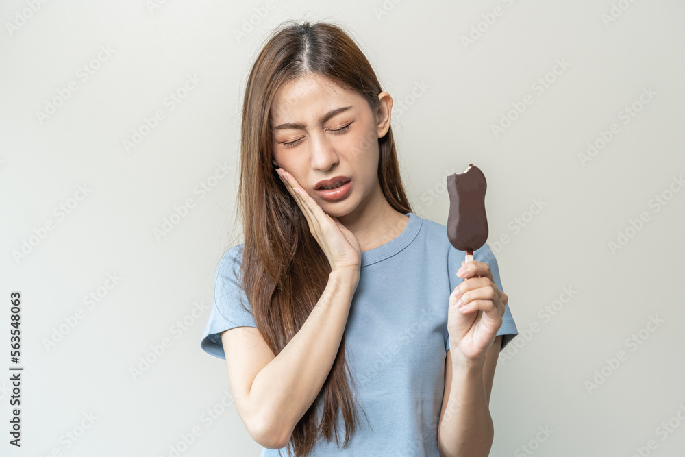 Face expression suffering from sensitive teeth and cold, asian young