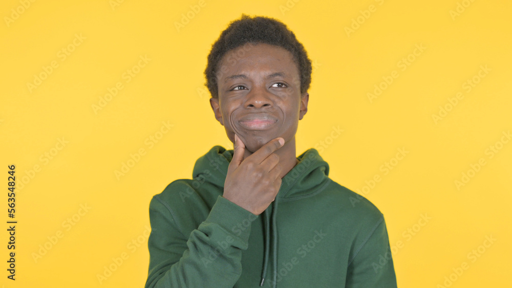 Fototapeta premium Brainstorming Young African Man Thinking Idea on Yellow Background
