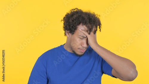 Tense African Man with Headache on Yellow Background