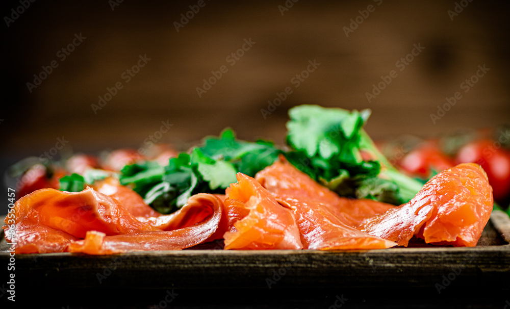 Pieces of salted salmon with parsley on the table. Pieces of salted salmon with parsley on the table.