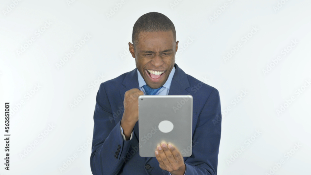 African Businessman Celebrating Success on Tablet on White Background African Businessman Celebrating Success on Tablet on White Background