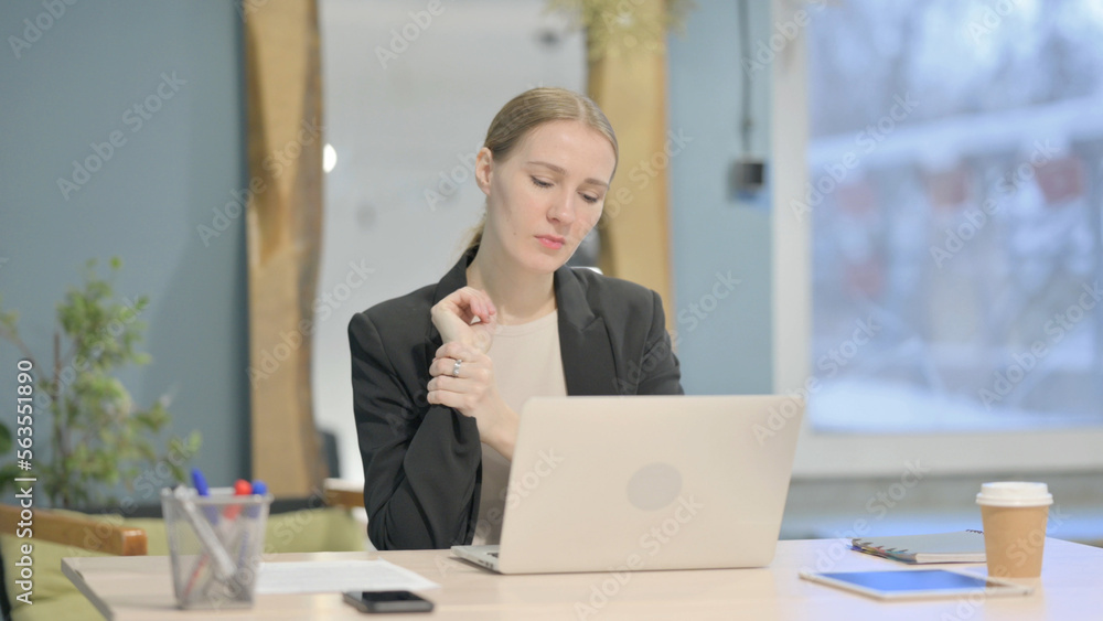 Businesswoman having Wrist Pain while using Laptop Businesswoman having Wrist Pain while using Laptop